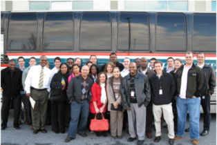 Picture of interns in front of a bus